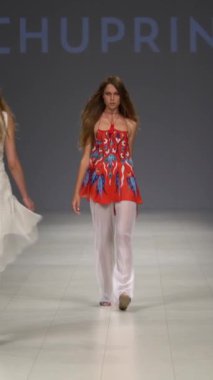 Woman model on the catwalk during a fashion show Vertical video