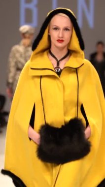 Woman model on the catwalk during a fashion show Vertical video