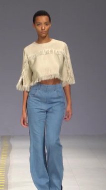 Woman model on the catwalk during a fashion show Vertical video
