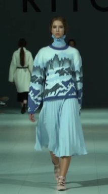 Woman model on the catwalk during a fashion show Vertical video