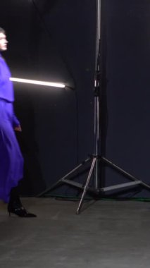 Woman model on the catwalk during a fashion show Vertical video