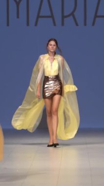 Woman model on the catwalk during a fashion show Vertical video