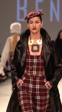 Woman model on the catwalk during a fashion show Vertical video