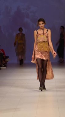 Woman model on the catwalk during a fashion show Vertical video