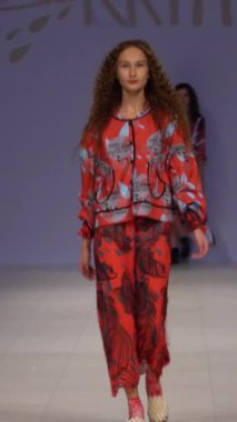 Woman model on the catwalk during a fashion show Vertical video