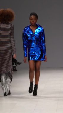 Woman model on the catwalk during a fashion show Vertical video