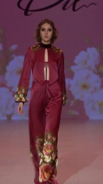 Woman model on the catwalk during a fashion show Vertical video