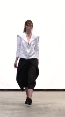 Woman model on the catwalk during a fashion show Vertical video