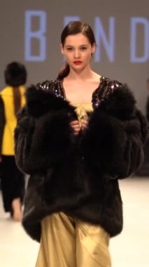 Woman model on the catwalk during a fashion show Vertical video