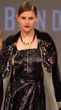 Woman model on the catwalk during a fashion show Vertical video