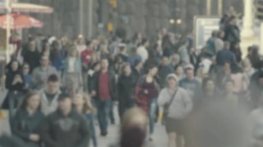 Şehirdeki hayat: insanların siluetleri kalabalıkta yürüyor, ağır çekimde.