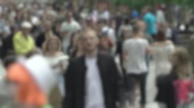 Megapolis: silhouettes of people walking in a crowd