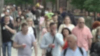 Megapolis: silhouettes of people walking in a crowd