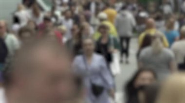 Megapolis: silhouettes of people walking in a crowd