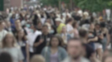 Megapolis: silhouettes of people walking in a crowd