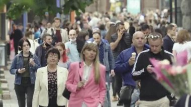 Birçok insan metropol caddesi boyunca yürür.