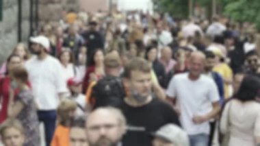 Silhouettes of people walking in the crowd