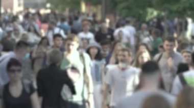 Silhouettes of people walking in the crowd