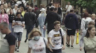 Silhouettes of people walking in the crowd