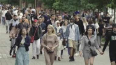Silhouettes of people walking in the crowd