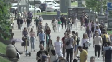 Silhouettes of people walking in the crowd