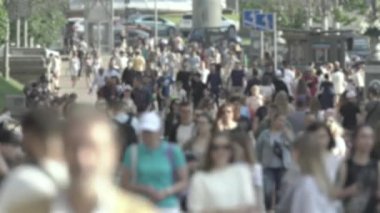 Silhouettes of people walking in the crowd