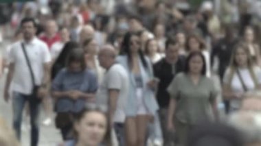 Silhouette of a crowd in a metropolis during the day