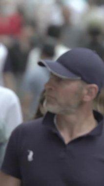 Vertical video of a crowd of people in the city