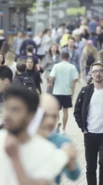 Vertical video of a crowd of people in the city