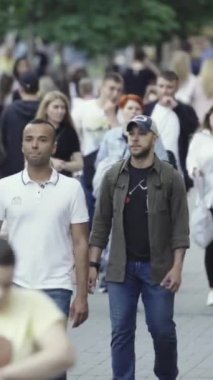 Vertical video of a crowd of people in the city