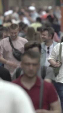 Vertical video of a crowd of people in the city