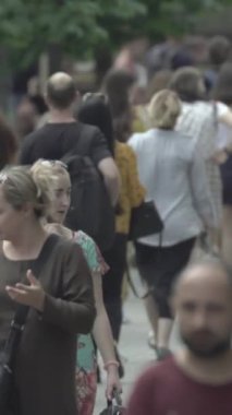 Vertical video of a crowd of people in the city
