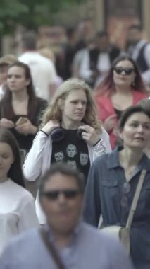Vertical video of a crowd of people in the city