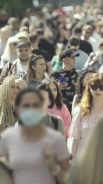 Vertical video of a crowd of people in the city