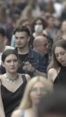 Vertical video of a crowd of people in the city