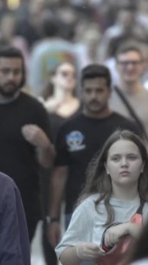 Vertical video of a crowd of people in the city