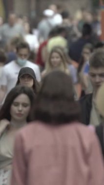Vertical video of a crowd of people in the city