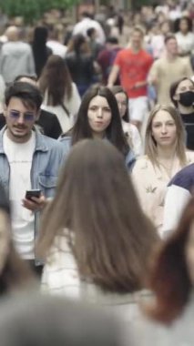 Vertical video of a crowd of people in the city