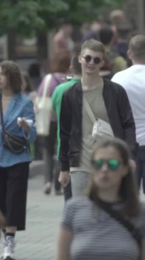 Vertical video of a crowd of people in the city