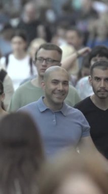 Vertical video of a crowd of people in the city