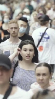 Vertical video of a crowd of people in the city