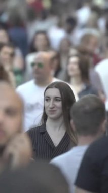 Vertical video of a crowd of people in the city
