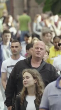 Vertical video of a crowd of people in the city