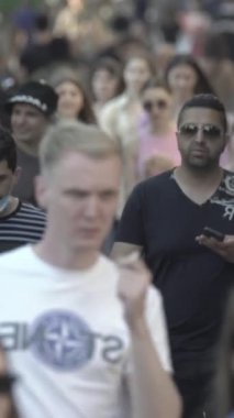 Vertical video of a crowd of people in the city