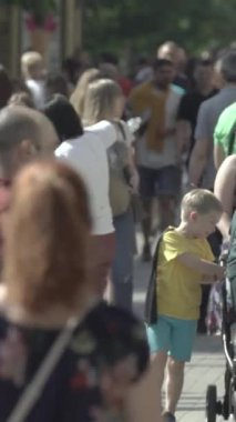 Vertical video of a crowd of people in the city