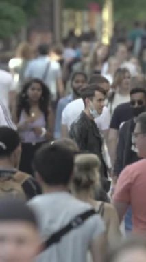 Vertical video of a crowd of people in the city
