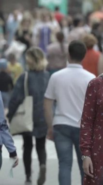 Vertical video of a crowd of people in the city
