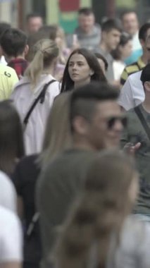 Vertical video of a crowd of people in the city