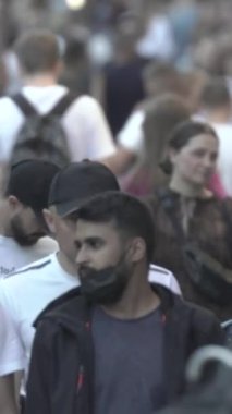 Vertical video of a crowd of people in the city