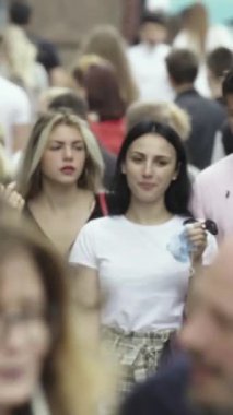 Vertical video of a crowd of people in the city